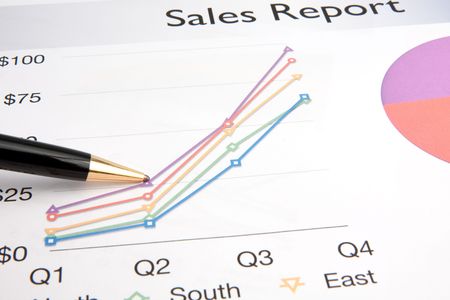 A pen rests on a business report containing details of product sales.