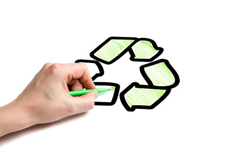 A male hand coloring in a recycling logo.の写真素材