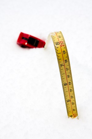 A measuring tape showing a snow depth of 10cm (4 inches)の写真素材