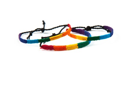 Three colourful friendship bracelets tied up.の写真素材