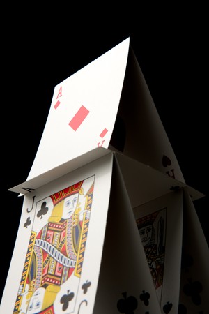 A house of cards on a black background.のeditorial素材