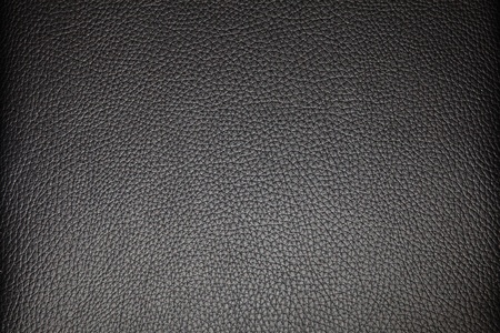A full frame texture of some black leather used on some furniture.