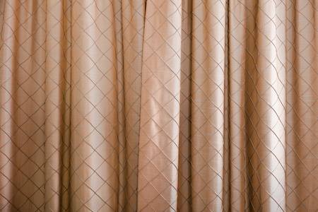 A full frame background of some closed brown curtains with a diamond pattern.の写真素材