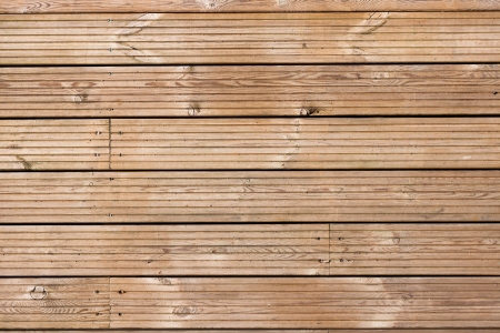 Full frame image of wooden decking flooring with grain pattern and screw heads の写真素材