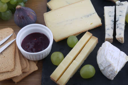 cheese board variety with grapes and figs