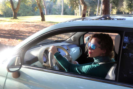 woman portraits with a retro car as freedom concept