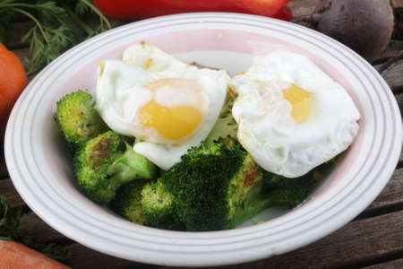 fried eggs with vegetables dishの写真素材