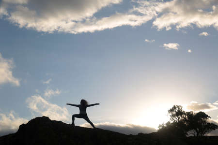 outdoors yoga meditation silhouette in the skyの写真素材