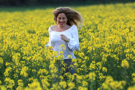woman portrait with yellow flowers field background