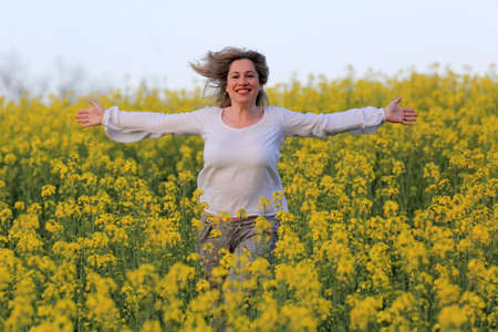 woman portrait with yellow flowers field background