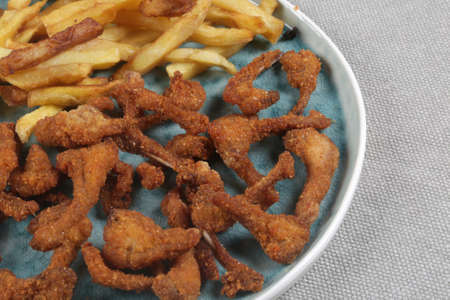 breaded rabbit ribs with fried potatoes