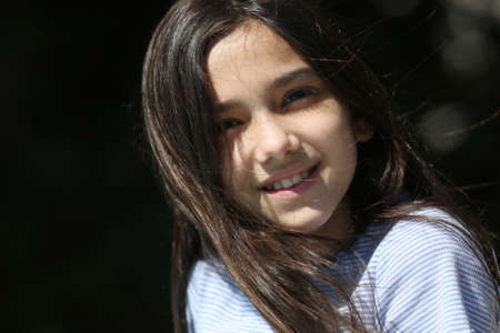 young brunette girl portrait outdoors