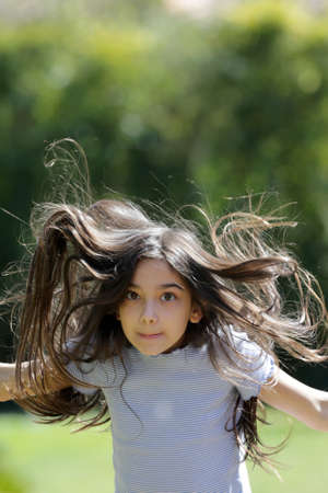 young brunette girl portrait outdoorsの写真素材