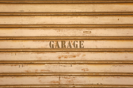 Old rusty metal door with the word GAZAGE written on itの写真素材