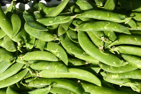 Green peas for sale at the farmer's market, closeup of photo