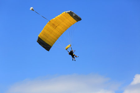 Parachutist flying in the blue sky, closeup of photoの写真素材