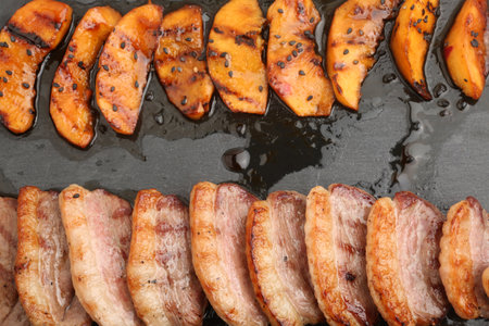 Delicious grilled peach slices on pan, closeup. Delicious snackの写真素材