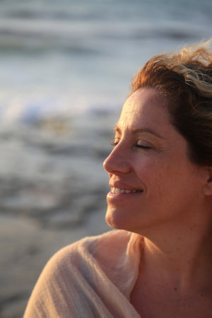 Portrait of a beautiful middle-aged woman smiling on the beach