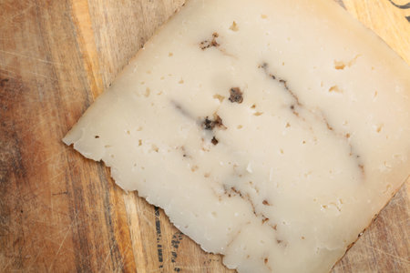 Parmesan cheese on wooden cutting board, closeup of photoの写真素材
