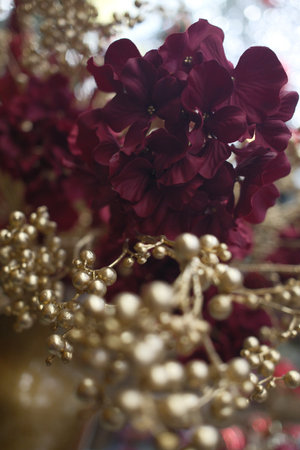 Close-up of a red hydrangea and gold beadsの写真素材