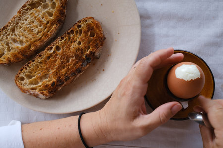 Breakfast with bread and eggs on a plate. Selective focus.の写真素材