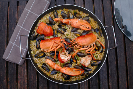 Seafood paella in a pan on a wooden background.の写真素材