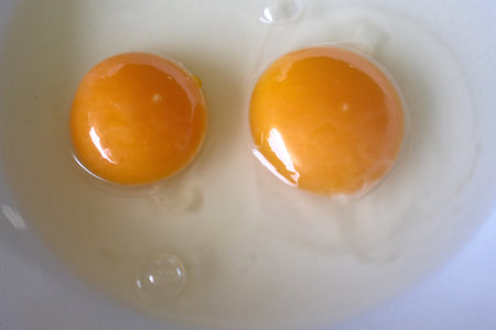 Eggs in a white bowl. Close-up view.の写真素材