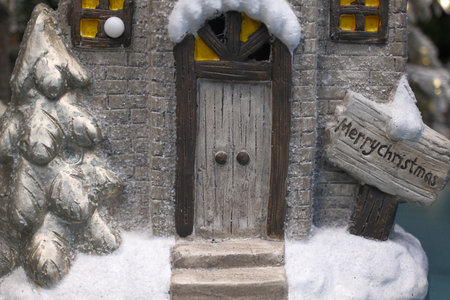 Christmas decoration in the form of a gingerbread house in the snowの写真素材