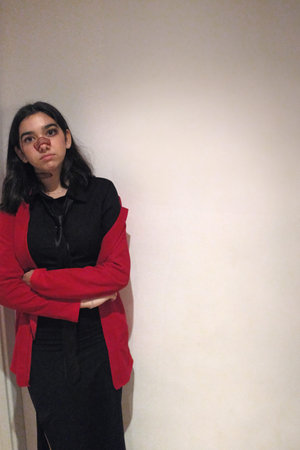 Portrait of a young brunette woman in a red jacket