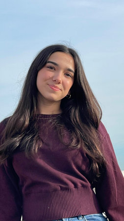 Portrait of a beautiful young woman with long black hair and brown eyes