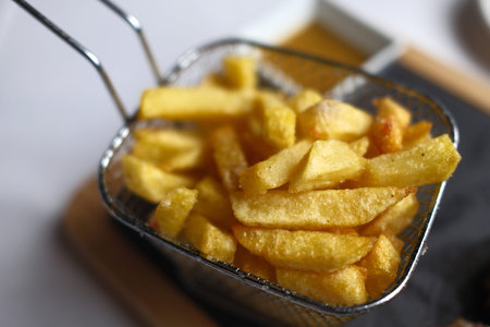 French fries in a basket, close-up. Selective focus.