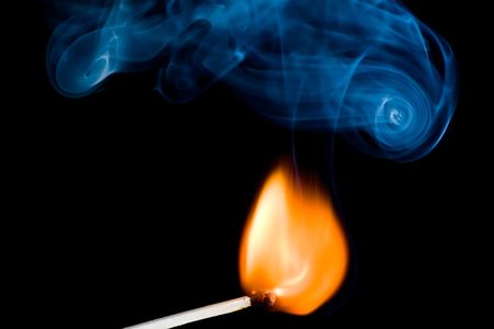 burning match on the black backgroundの写真素材
