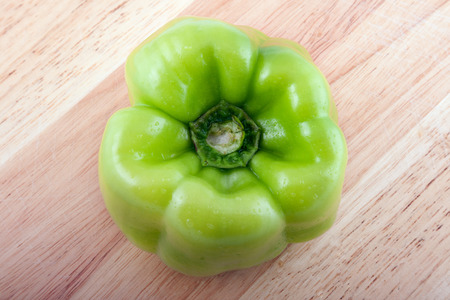 Green paper on a wooden boardの写真素材