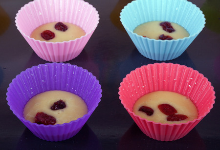 Four muffin's form with dough on a roasting panの写真素材