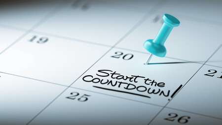 Concept image of a Calendar with a blue push pin. Closeup shot of a thumbtack attached. The words Start Countdown written on a white notebook to remind you an important appointment.の写真素材