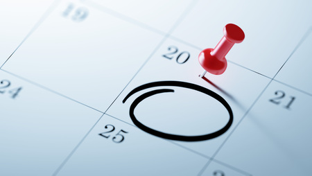 Concept image of a Calendar with a red push pin. Closeup shot of a thumbtack attached. Circle mark written on a white notebook to remind you an important appointment.の写真素材