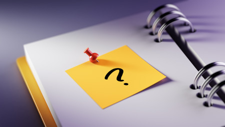 Closeup Yellow Sticky Note paste it in a notebook setting an appointment. Question Mark written on a white notebook to remind you an important appointment.の写真素材