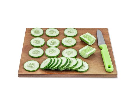 cucumber sliced in wooden board on white backgroundの写真素材