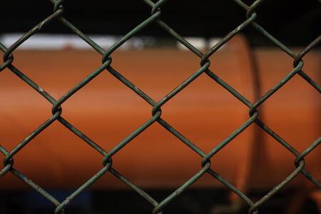 old and rusty green chain fence puts up on factory for security reason