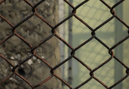 old and rusty chain fence put surround in building for secure unauthorized access.