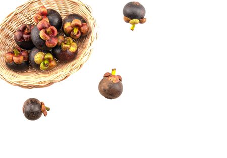 fresh mangosteen on basket isolated in white background の写真素材