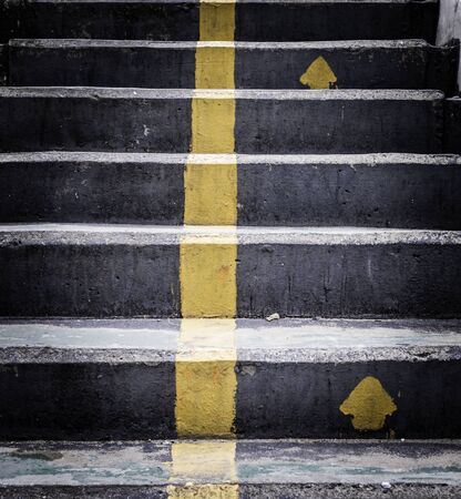 old cement walking stairs with  yellow lineの写真素材