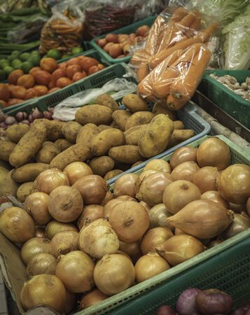a lot of fresh vegetable put to sell on the market like potato, tomato,carrot,onion,chilli etcの写真素材