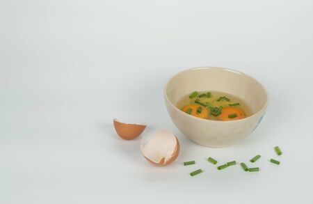 raw eggs in ceramic bowl prepare for cooking on the kitchen in white background