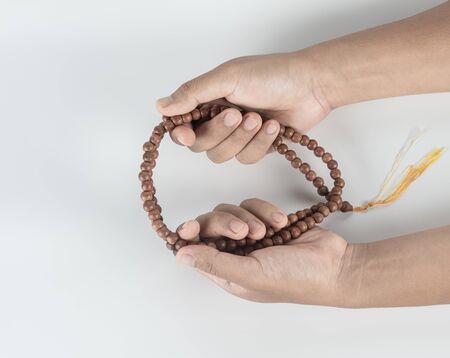 hands hold mala necklace for mediatation to  healing mind from stress  isolated on white backgroundの写真素材