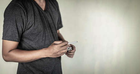 man holds cigarette on hands concept for narcotic  or crime  with old colour effect style.の写真素材