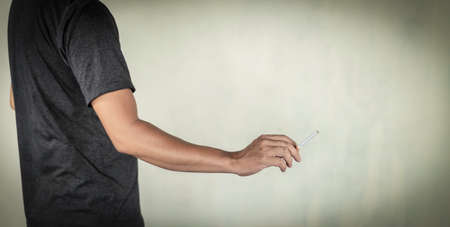 man holds cigarette on hands concept for narcotic  or crime.の写真素材