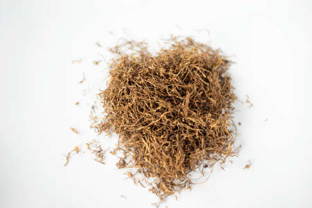 close up heap of tobacco on white background from overhead view.の写真素材