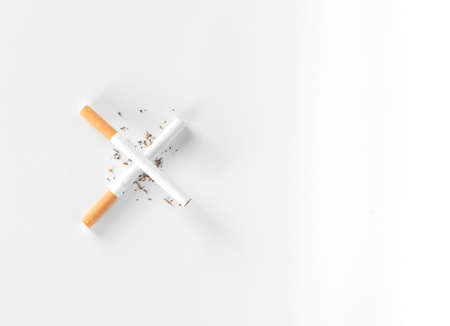 cigarettes lay as a cross sign in white background from top view with copy space.quit smoke , world tobecco concept.の写真素材