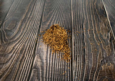 pile of tobacco on a wooden background.の写真素材